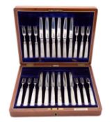 A cased set of twelve Edward VII silver and mother of pearl fruit knives and forks by Brook & Son,