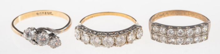 A group of three rings, including a 9ct gold seven stone ring set with circular-cut paste stones,
