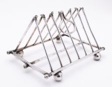 An early 20th century seven bar silver plated folding toast rack, not marked, with tubular bars,