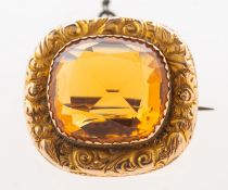 A citrine brooch, a rectangular mixed-cut citrine set in a foliate carved border,