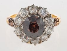 An antique cognac diamond and diamond cluster ring,