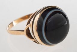 A banded agate ring, collet set with a circular banded agate cabochon, enclosed back setting,