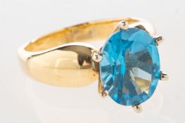 A blue topaz ring, claw set with an oval-cut blue topaz, marked 14K, size N1/2, 6.7grams.