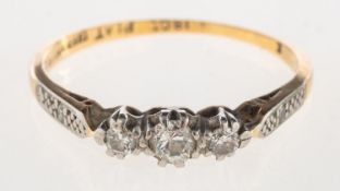 A three stone diamond ring, claw set with three old-cut diamonds,