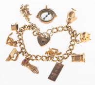A charm bracelet with charms and a loose compass charm,