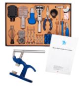 A cased watch repair set and watch press.