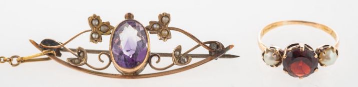 A garnet and pearl ring and an amethyst and seed pearl brooch, an antique three stone ring,