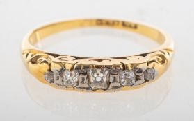 An antique five stone diamond ring, set with five graduated old-cut and cushion-cut diamonds,
