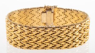 A wide articulated link bracelet, with textured and polished links,