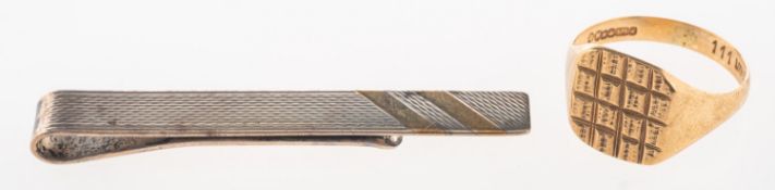 A 9ct gold ring and a silver tie slide,