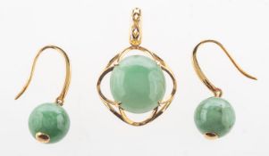 A jade pendant and jade earrings, an openwork pendant claw set with a circular jade cabochon,