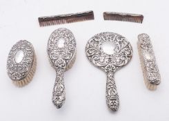 An Elizabeth II matched six piece silver dressing table set mostly by W I Broadway & Co,