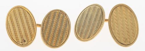 A pair of oval cufflinks, with lined engine turned engraving to both faces, bar link,