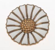 Georg Jensen. An enamelled daisy brooch, a gilt and white enamelled brooch in the form of a daisy,