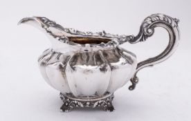 A Victorian silver cream jug by Benoni Stephens, London 1839, of compressed melon form,
