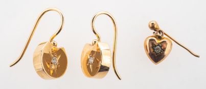A pair of diamond drop earrings and a single earring, a pair of drop earrings,