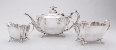 An Edward VII three piece silver tea service by George Wish, Sheffield 1906, of shaped oval form,
