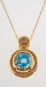A blue topaz and diamond pendant with chain,