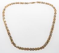 A tri-colour 'kiss' necklace, the necklace of alternating tri-colour 'kiss' ('X') links,