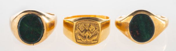 A group of three rings, including two 9ct gold bloodstone signet rings, both UK hallmark,