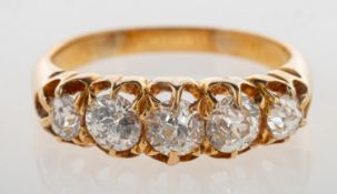 An antique five stone diamond ring, claw set with five graduated old mine-cut diamonds,
