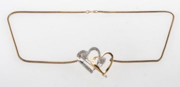 A quadruple heart diamond brooch pendant with removable chain,
