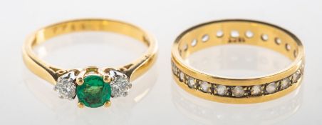 An 18ct gold emerald and diamond ring and one other ring, an 18ct gold three stone ring,