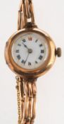 An early 20th century wristwatch, mechanical wind with circular white ceramic dial, Roman numerals,