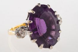 An 18ct gold amethyst and diamond ring, claw set with an oval-cut amethyst, amethyst approx. 14.