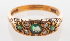 A 9ct gold emerald and diamond ring, set with three circular-cut emeralds,