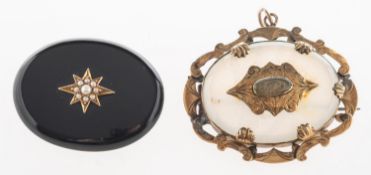 A group of two gilt Victorian mourning brooches, including an oval jet brooch,
