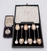 Trap shooting prize; A George V cased silver fob in the form of a clay pigeon