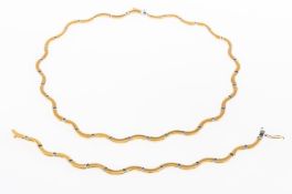 A matching bi-colour necklace and bracelet, of wavy brushed and polished finish bi-colour links,