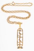 A hieroglyph pendant with chain, an openwork pendant with Egyptian hieroglyphs,