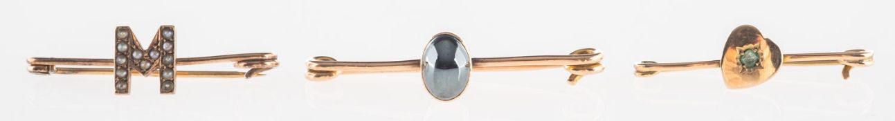 A group of three brooches,