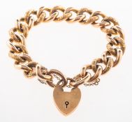 A charm bracelet, with heart padlock, safety chain and alternate carved patterned links,
