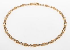 A 9ct gold necklet, of articulated open oval links, interspaced by cross and bar links,