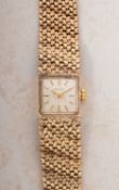 Jean Renet, a 9ct gold lady's wristwatch the square silvered dial having raised baton numerals,