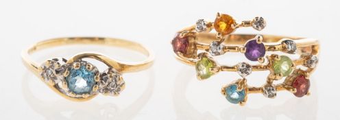 Two gem-set rings, including a 9ct gold three stone twist ring, set with a circular-cut blue topaz,