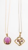 Two ruby pendants with chains, including a pendant set with an oval star ruby cabochon,