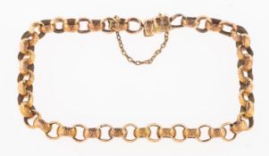 A Victorian bracelet, of open engraved patterned links, push-in clasp and safety chain,