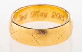 A wedding band, with 'X' engraving spaced around the outside of the band, marked 22, size N to N1/2,
