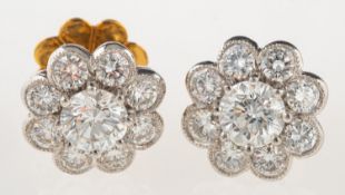 A pair of fine diamond cluster earrings, of flowerhead design,