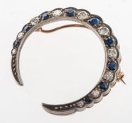 A diamond and sapphire crescent brooch,