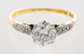 A diamond solitaire ring, a bi-colour ring, claw set with a transitional-cut diamond,