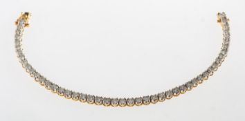 A diamond line bracelet, a bi-colour articulated bracelet,