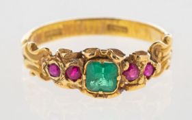An emerald and ruby ring, an ornate scroll carved ring, possibly Victorian,