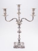 A matched Edward VII silver candelabra by Hawksworth, Eyre & Co Ltd, Sheffield 1917- base,