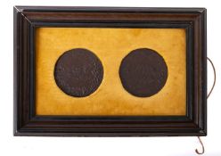 A farmed pair of Uniface plaques, showing 19th century Romanesque busts and battle scenes,