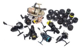 A collection of eight fishing reels.